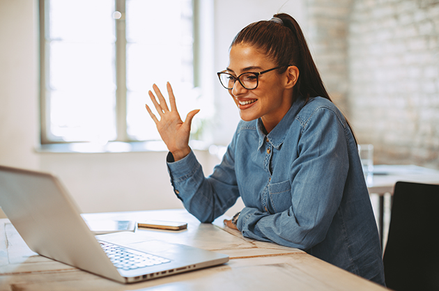 Lady waving at laptop